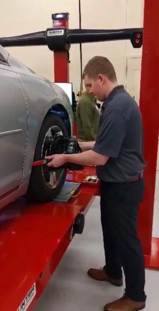A young man replacing a tire with a hunter brand machine